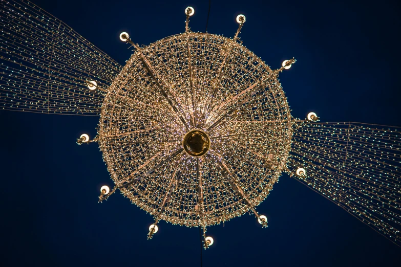 a chandelier hanging from the ceiling of a building, by Bruce Munro, pexels contest winner, intricate ornament halo, many stars, golden detailing, dyson sphere