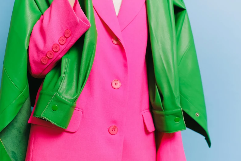 a woman in a pink dress and green jacket, trending on pexels, pop art, subject detail: wearing a suit, in the style of john baldessari, synthetic materials, wearing leather