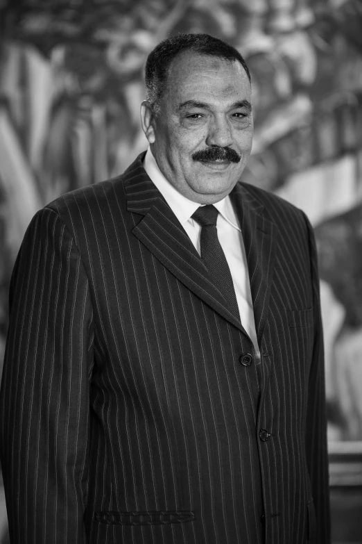 a man wearing a suit with a mustache