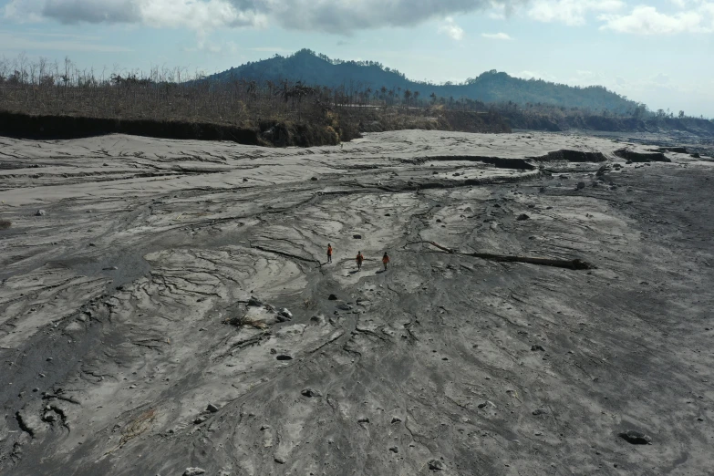 there are tracks in the dirt next to hills