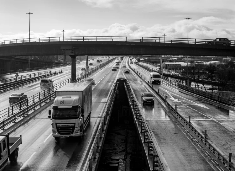 a bus and truck are on a large highway