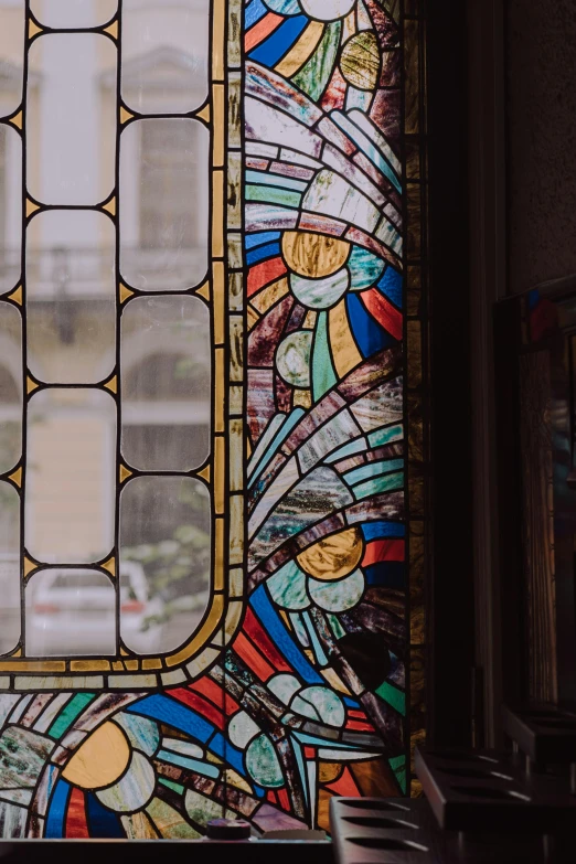 a stained glass window sitting inside of a building