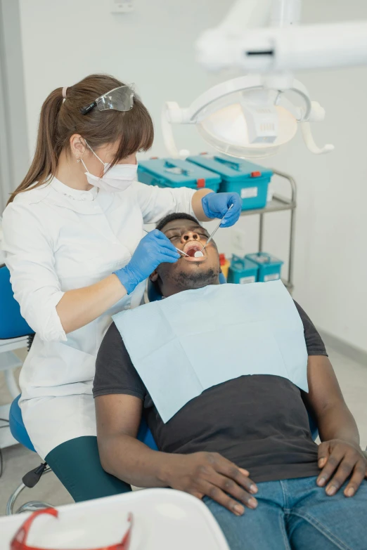 a man getting his teeth examined by a dentist, pexels contest winner, renaissance, black, square masculine jaw, made of lab tissue, opalescence