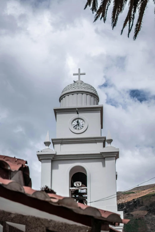 a clock tower on the side of a building, quito school, rounded roof, holy cross, as seen from the canopy, white