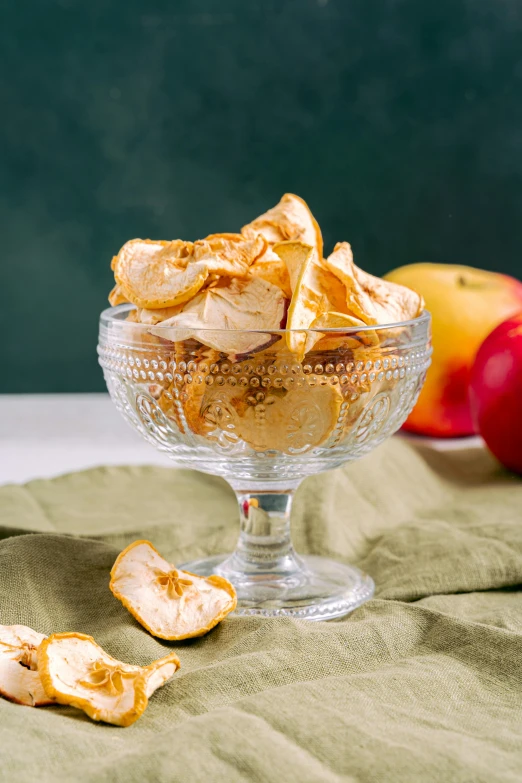 a close up of a bowl of food on a table, golden apple, product image, dried petals, chiffon