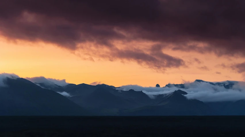 a small plane flying into the air next to mountains