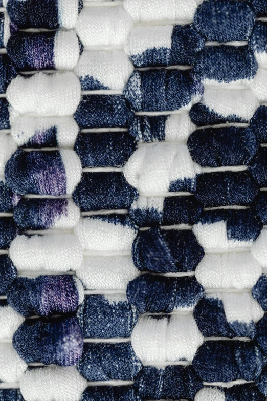 a close up of a piece of fabric, blue and white, knitted mesh material, muted multi-color lapis, product shot