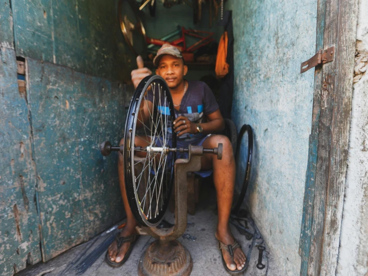 a man sits in the doorway of a shop