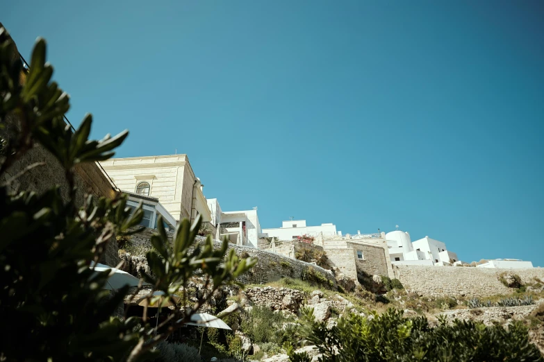 an outside area with small white buildings and vegetation