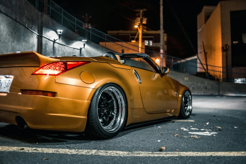 a car parked in a parking lot at night, inspired by Kentaro Miura, unsplash, soft top, tokyo drift, gold tint, brown