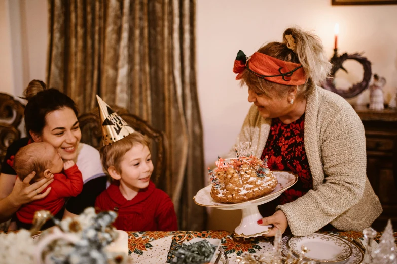 a group of people sitting around a table with a cake, wearing festive clothing, profile image, family friendly, brown