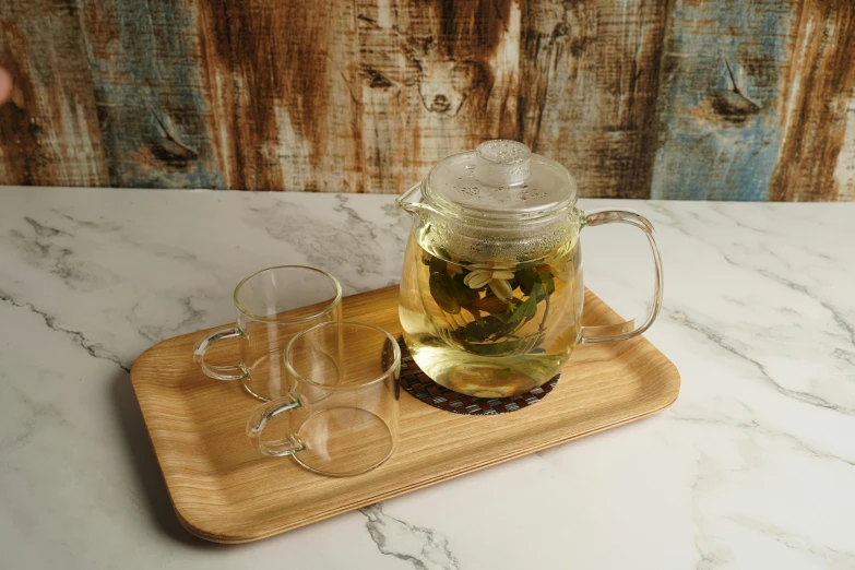 a tea pot sitting on top of a wooden tray, pexels, glass labware, 3 - piece, ready to eat, taiga