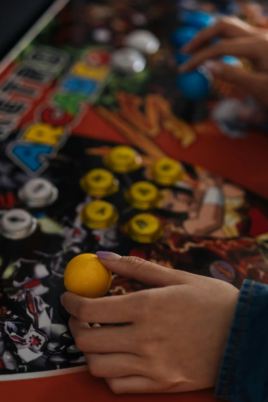 a person with their hands on an arcade