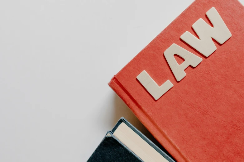 a law book sitting on top of a stack of books, by Carey Morris, trending on pexels, red writing, asset on grey background, flat lay, laced