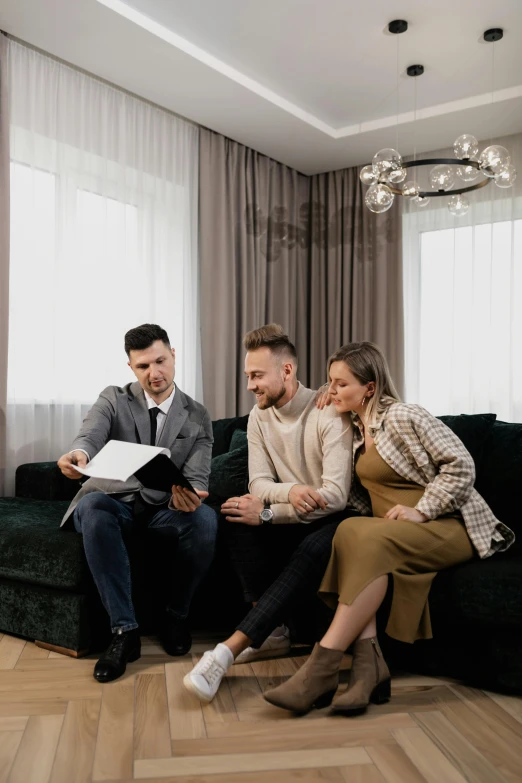 a group of people sitting on a couch in a living room, selling insurance, jakub rebelka, elegant style, document photo