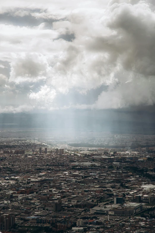 a city and mountains are seen from an airplane