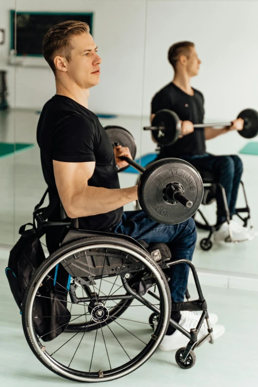 a man in a wheel chair with a barbell, profile image, 2 people, body fit, sitting with wrists together