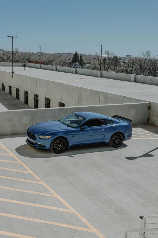 a blue car parked next to an empty parking lot