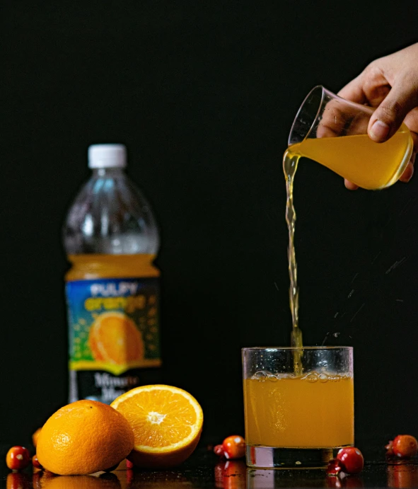 a person pouring orange juice into a glass, by Jan Rustem, pexels, still life photo of a backdrop, energy drink, pullitzer winning, pulp