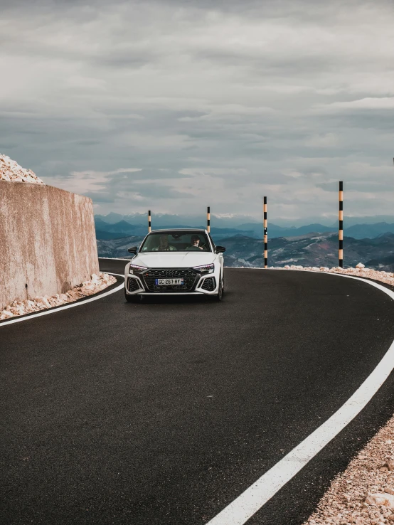 an suv driving along a hilly road in the mountains