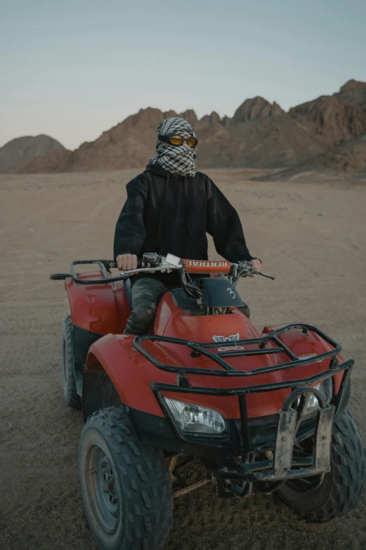 man on quad on desert surface in heavy gear