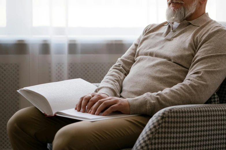 a man sitting in a chair reading a book, pexels contest winner, portrait of hide the pain harold, tight wrinkled cloath, an ultra realistic, old gigachad with grey beard