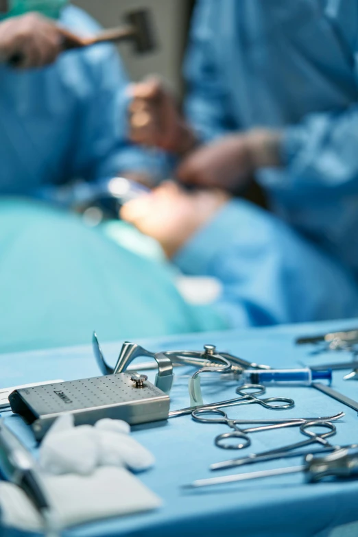 a group of medical equipment sitting on top of a blue table, a picture, by Bernard Meninsky, shutterstock, happening, heart operation, close - up photograph, tiny waist, surgeon