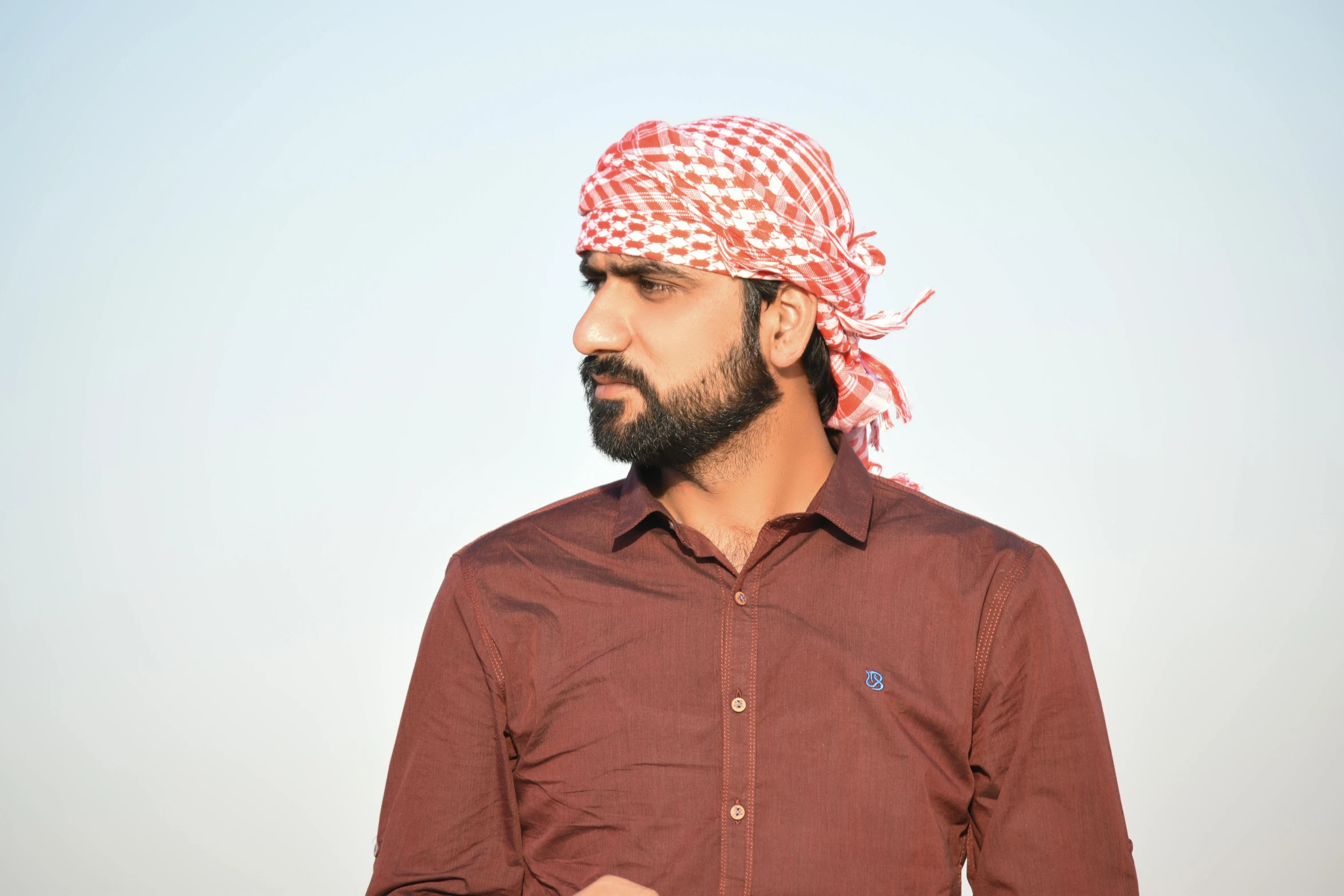 a man in a red shirt has a bandanna on