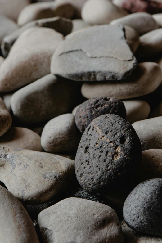 a pile of rocks sitting on top of a table, an album cover, unsplash, ((rocks)), low detail, volcanic, beans
