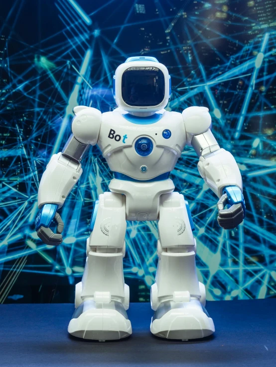 a robot that is standing on a table, with a blue background, in the background