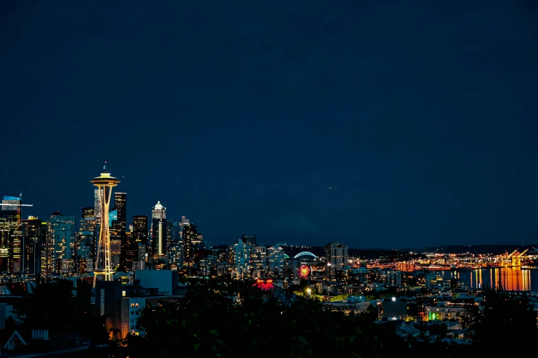 a view of a city at night from the top of a hill, by Meredith Dillman, unsplash contest winner, the space needle, plain background, background image