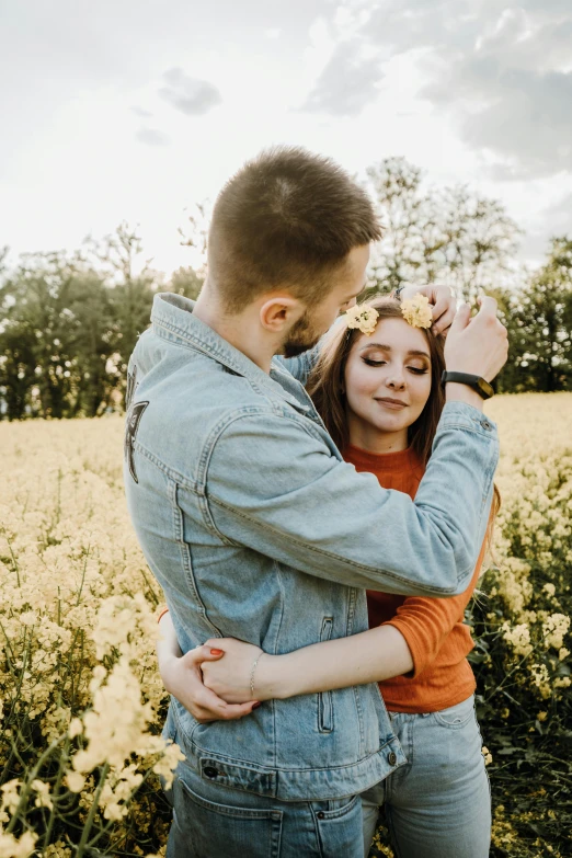 a couple is in the middle of an outdoor field of flowers