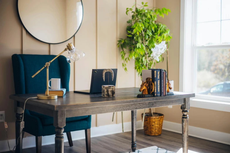 a living room with two books, a plant and a lamp