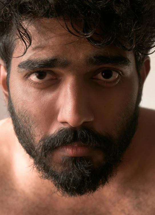 a close up of a man with a beard, reddit, provocative indian, slightly muscular, movie filmstill, lgbtq