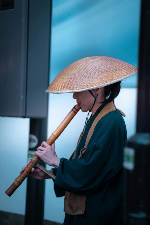 a woman in a straw hat holding a stick