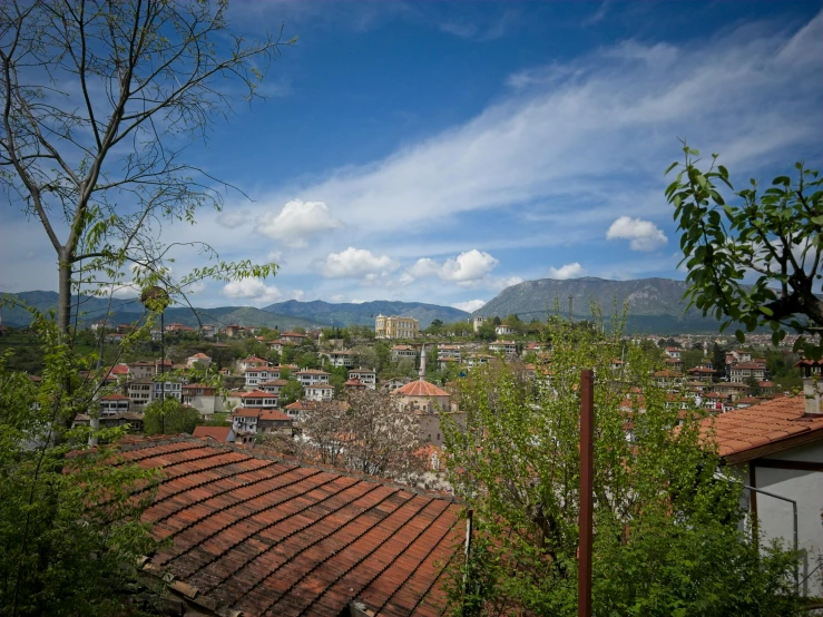 an urban area is seen on the horizon with mountains in the background