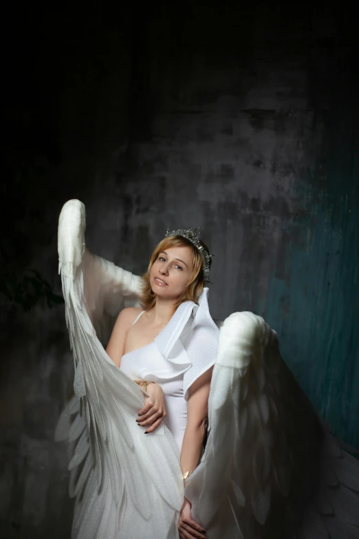 a woman in a white dress with angel wings, a portrait, inspired by Apollinary Vasnetsov, pexels contest winner, in a photo studio, wearing a wedding dress, 2010s, 5 0 0 px models