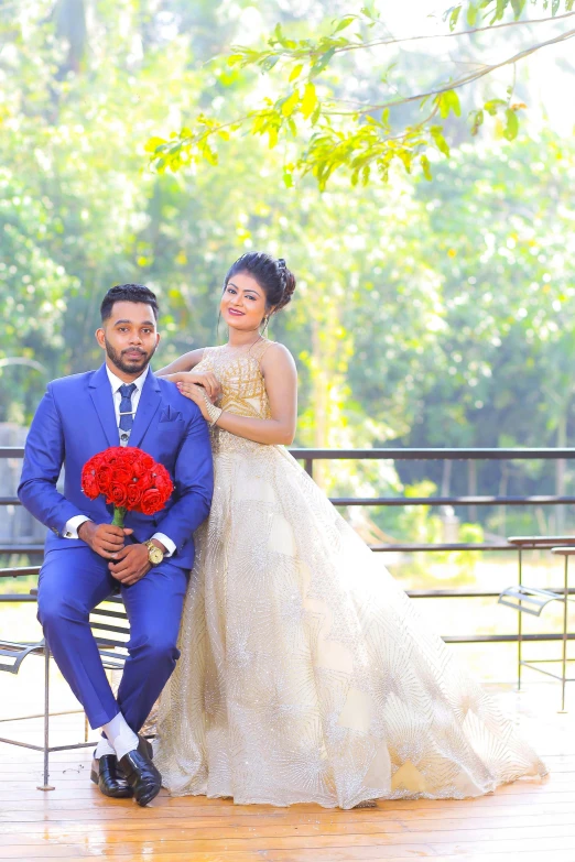 a man in a blue suit sitting next to a woman in a white dress, sri lanka, in wedding dresses, modeling photography, 👅 👅