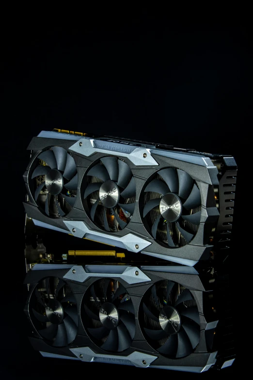 a couple of video cards sitting on top of a table, black armor with yellow accents, palladium, grey, panel