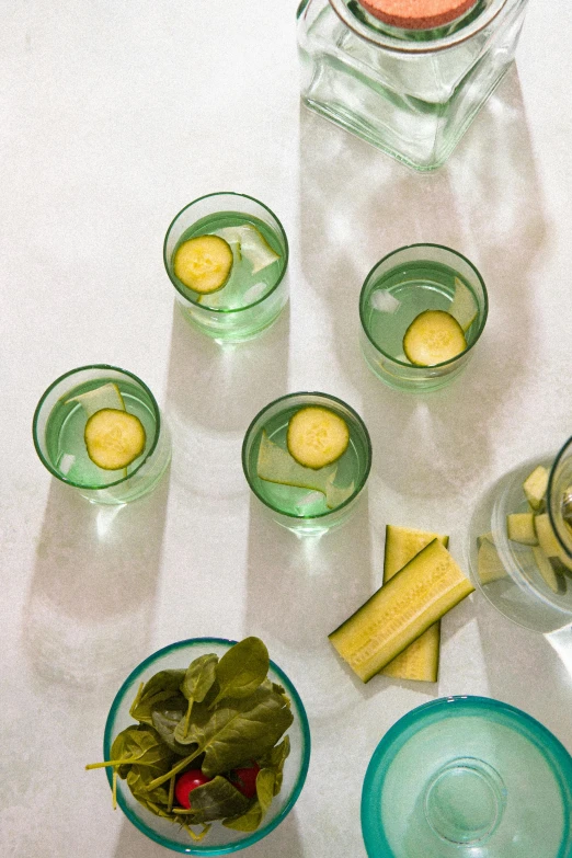 a table topped with bowls of food and glasses of water, cucumber, goddess shot, square, 4l