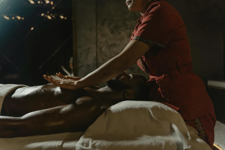 a woman is giving a man a massage, pexels contest winner, dark and dusty, with brown skin, healing pods, cinematic full shot