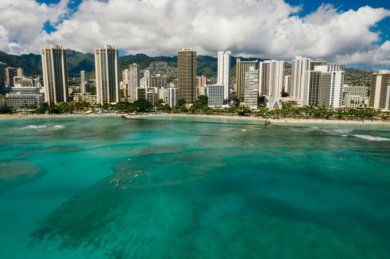 several buildings are on the shore of an ocean