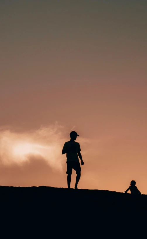 a couple of people standing on top of a hill, by Sebastian Spreng, pexels contest winner, minimalism, kids playing, 15081959 21121991 01012000 4k, warm glow, walking boy