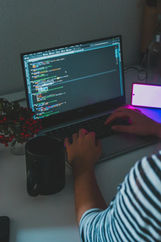 a person sitting at a desk using a laptop computer, by Adam Marczyński, trending on unsplash, pixel art, engineering, python, add a glow around subj. edge, integrated synthetic android