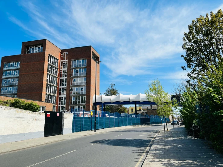 a street with an overpass and a building in the background