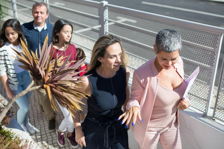 a group of people walking down a sidewalk, by Almada Negreiros, happening, president of brazil, malika favre, pink, eva elfie