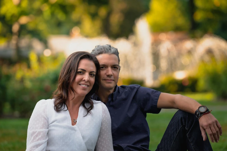 a man and a woman sitting next to each other, a picture, professional color photography, park in background, avatar image, giorgia meloni