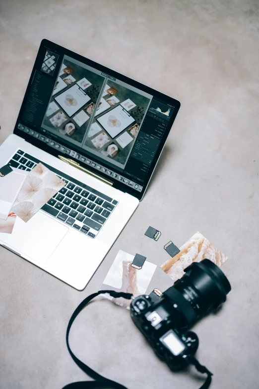 a laptop computer sitting on top of a table next to a camera, a picture, looking down on the camera, designer product, photograph, visa pour l'image