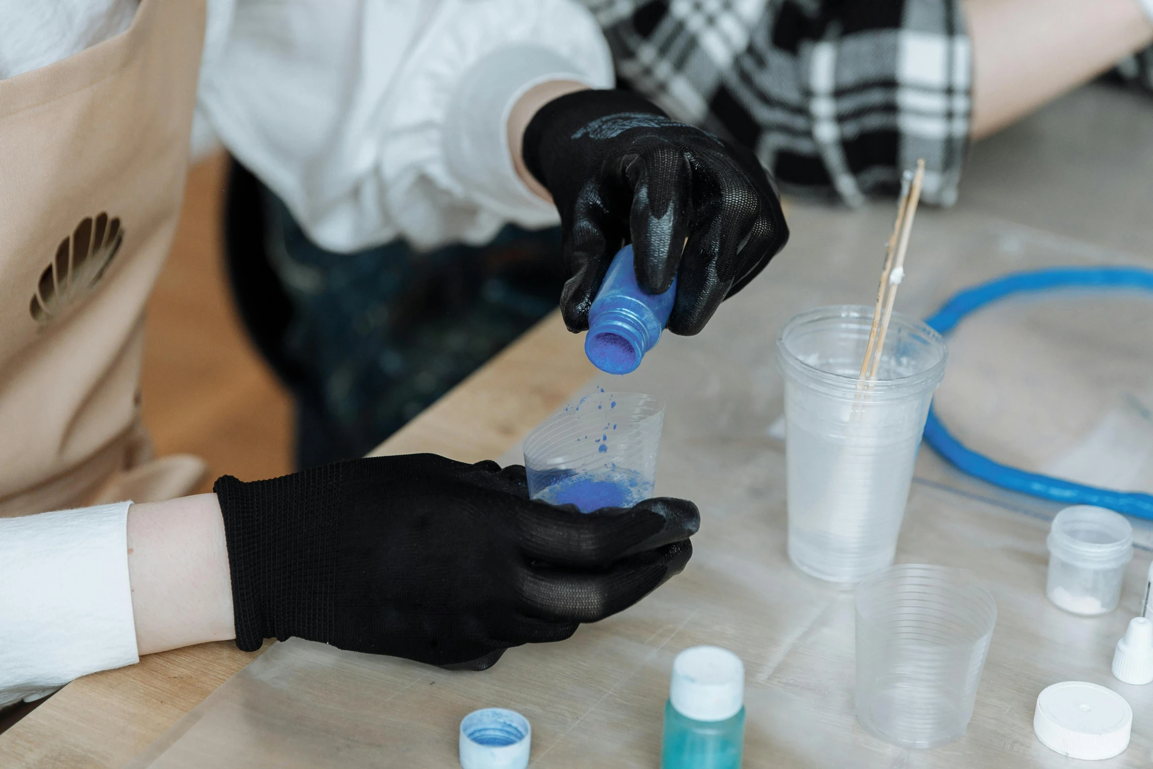 a person in a white shirt and black gloves, process art, beakers of colored liquid, black and blue scheme, thumbnail, inspect in inventory image