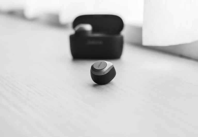 a pair of earphones sitting on top of a table, a black and white photo, by Mathias Kollros, alexa mini, flat icon, möbius, miniature product photo